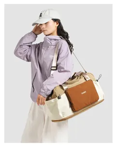 Detailed view of the color-blocked nylon travel duffel bag with dry-wet separation and expandable design.