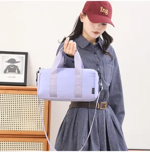 Detail view of a light purple minimalist waterproof gym barrel bag with comfortable straps.