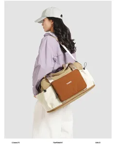 Detail view of the nylon travel duffel bag showcasing color-blocked design and carrying strap.