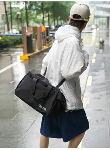 Black travel duffel bag detail with waterproof fabric and stylish front lettering.
