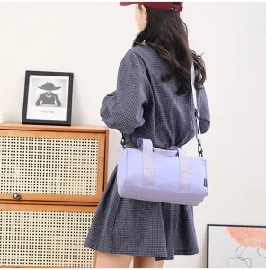 Detail view of a stylish light purple cylindrical gym bag, perfect for yoga, travel, and fitness.