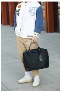 Details of stylish casual travel duffel bag with durable handle and practical flap.