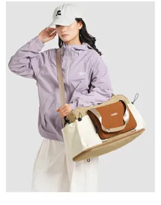 Detailed view of the color-block travel bag, highlighting the wet-dry separation pocket.