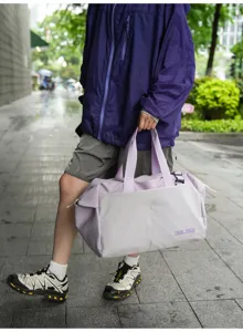 Detail view of the stylish large capacity travel duffel bag handle and contrast color block.