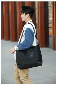 Stylish black canvas travel duffel bag with shoulder strap, perfect for gym, sports and trips.