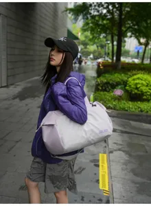 Close-up of the stylish large-capacity duffel travel bag in color-block grey and purple.