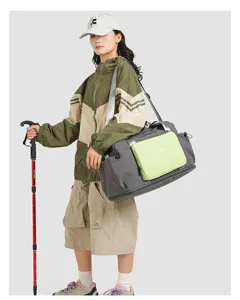 Detail view of a color-block nylon travel duffel bag with dry-wet separation for hiking and camping.