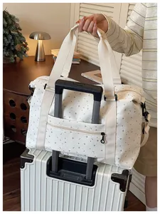 Large capacity travel duffel bag for women, portable gym bag and luggage organizer.
