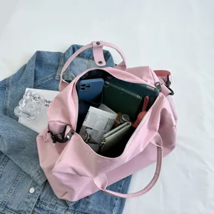Large capacity pink travel duffel bag for women, waterproof gym bag with shoe compartment.