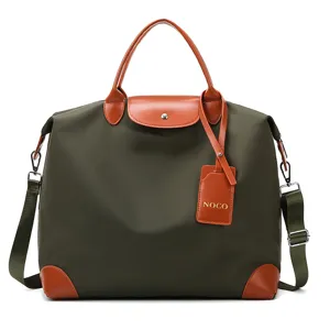Stylish nylon travel bag with brown leather trim, large capacity portable luggage shoulder bag.