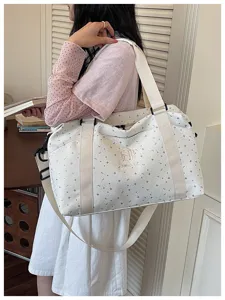 Large capacity travel duffel bag for women, lightweight gym and yoga bag with shoulder strap.