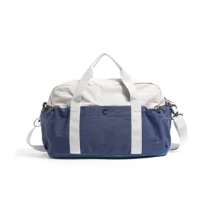 Large capacity blue and grey travel duffel bag main view with shoulder strap and handles.