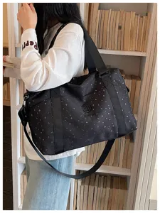Detail view of a large capacity travel gym bag with star pattern, durable straps and storage.