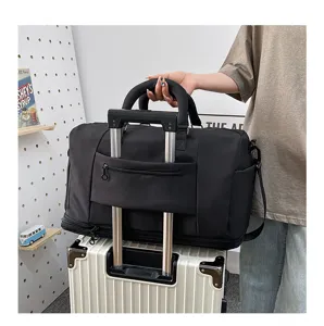 Detail view of black travel duffel bag on suitcase handle, large capacity with wet separation.