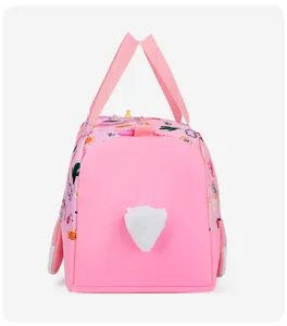 Close-up detail view of the cute pink children handbag featuring lovely cartoon prints and plush.