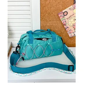 Teal waterproof sports duffel bag detail, nylon fabric, pink elastic cords, braided strap.