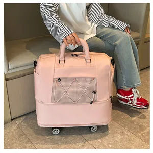 Pink rolling travel bag with wheels and handle, large capacity short trip luggage for women.