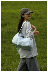 Light blue plaid travel bag with cute heart pattern, large capacity and lightweight for trips.