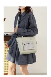 Detailed view of the stylish beige casual shoulder bag with front pocket design.