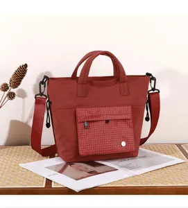 Red casual canvas tote bag with front pocket, stylish shoulder messenger bag for daily commuting.