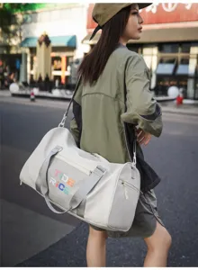 Detailed view of white sports fitness duffel bag with shoulder strap, ideal for travel and gym.