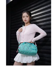 Detail view of water-resistant sports duffel bag with pink elastic cords for fitness commuting.