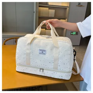 Detail shot of multi-functional travel duffel bag with star print and handles in use.