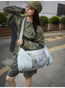 Stylish light blue gym duffel bag with grey straps and color print for travel and fitness.