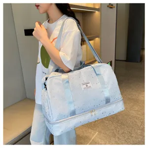 Detailed view of light blue travel duffel bag with star pattern and bottom shoe compartment.