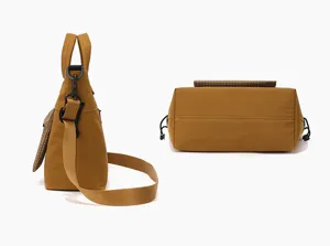 Side and bottom detail view of the brown canvas messenger bag with adjustable strap.