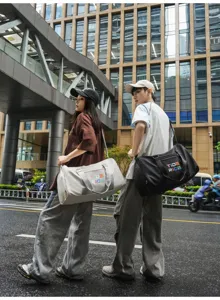 Detail view of the trendy fitness duffel bag showing urban lifestyle use and stylish design.