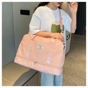 Pink travel duffel bag detail showing star pattern, dual-layer design and strap.