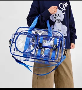Clear transparent travel duffel bag with blue straps and functional pockets for daily fitness.