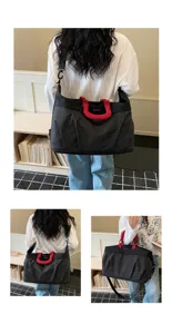 Large capacity travel duffel bag detail showing grid pattern, durable handles and shoulder strap.