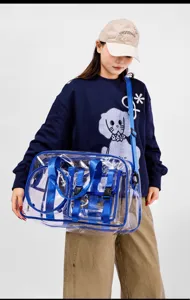 Transparent waterproof gym bag with blue straps, clear travel tote for beach and outdoor sports.
