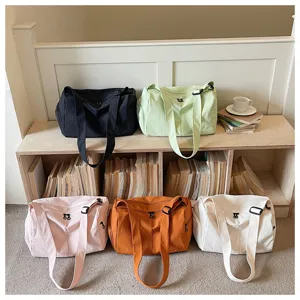 Detailed view of large capacity canvas travel duffel bag in multi-color options, lifestyle display.