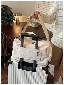 Large capacity travel duffel bag with trolley sleeve and shoulder strap for short trips.