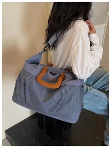Large capacity travel duffel bag with grid pattern, durable fitness gym bag for women.