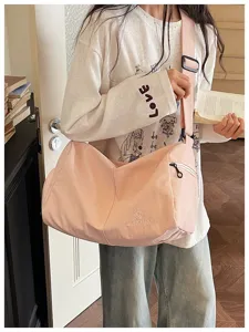 Lightweight pink crossbody fitness travel bag, large capacity casual luggage bag with strap.
