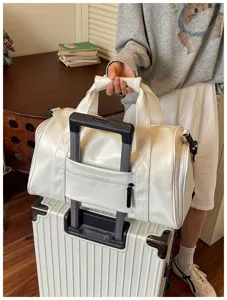 White travel duffel bag detail, large capacity gym bag with luggage sleeve for trip.