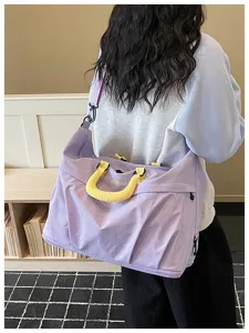 Large capacity purple travel duffel bag with yellow handles for fitness and short trips.