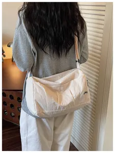 Casual minimalist shoulder travel bag lifestyle detail view, spacious daily carry bag.