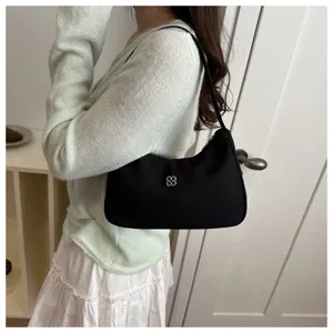 Elegant black minimalist underarm bag for women with chic silver flower hardware detail
