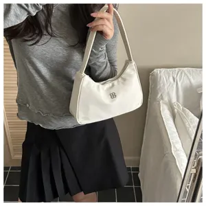 Minimalist white underarm shoulder bag for women with elegant metallic flower logo