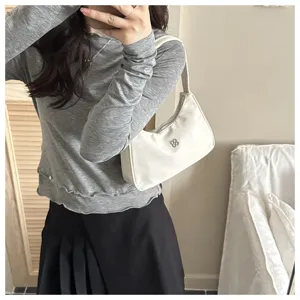 Elegant white nylon underarm shoulder bag for women with minimalist floral metal logo
