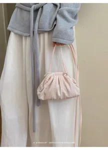 Small pink and white striped fabric cloud handbag with retro minimalist aesthetic details