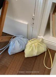Detailed view of minimalist striped and plaid crossbody bags in soft blue and yellow