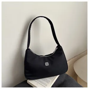 Elegant black nylon underarm shoulder bag for women with minimalist flower motif detail