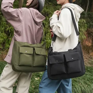 Casual canvas messenger bag with large capacity and double front pockets for outdoor travel daily use.