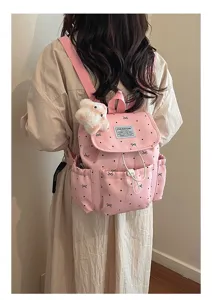 Back view of pink college style backpack with bow polka dot pattern and bear charm